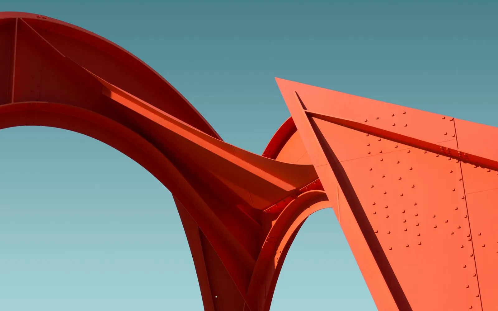 Riveted coral-orange steel arches against a teal sky, the image behind the Stoar brand